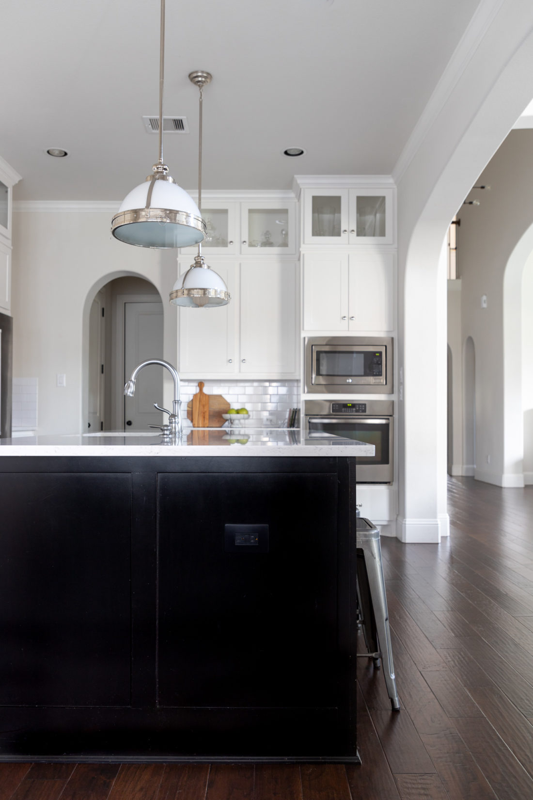 white kitchen cabinets with black island